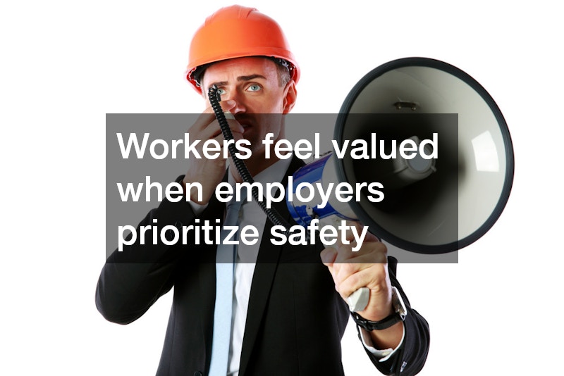 man in suit holding a megaphone and wearing a hard hat